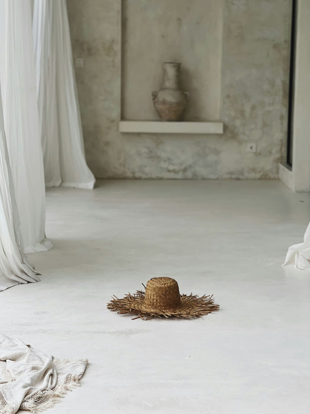 a straw hat on the floor of a room