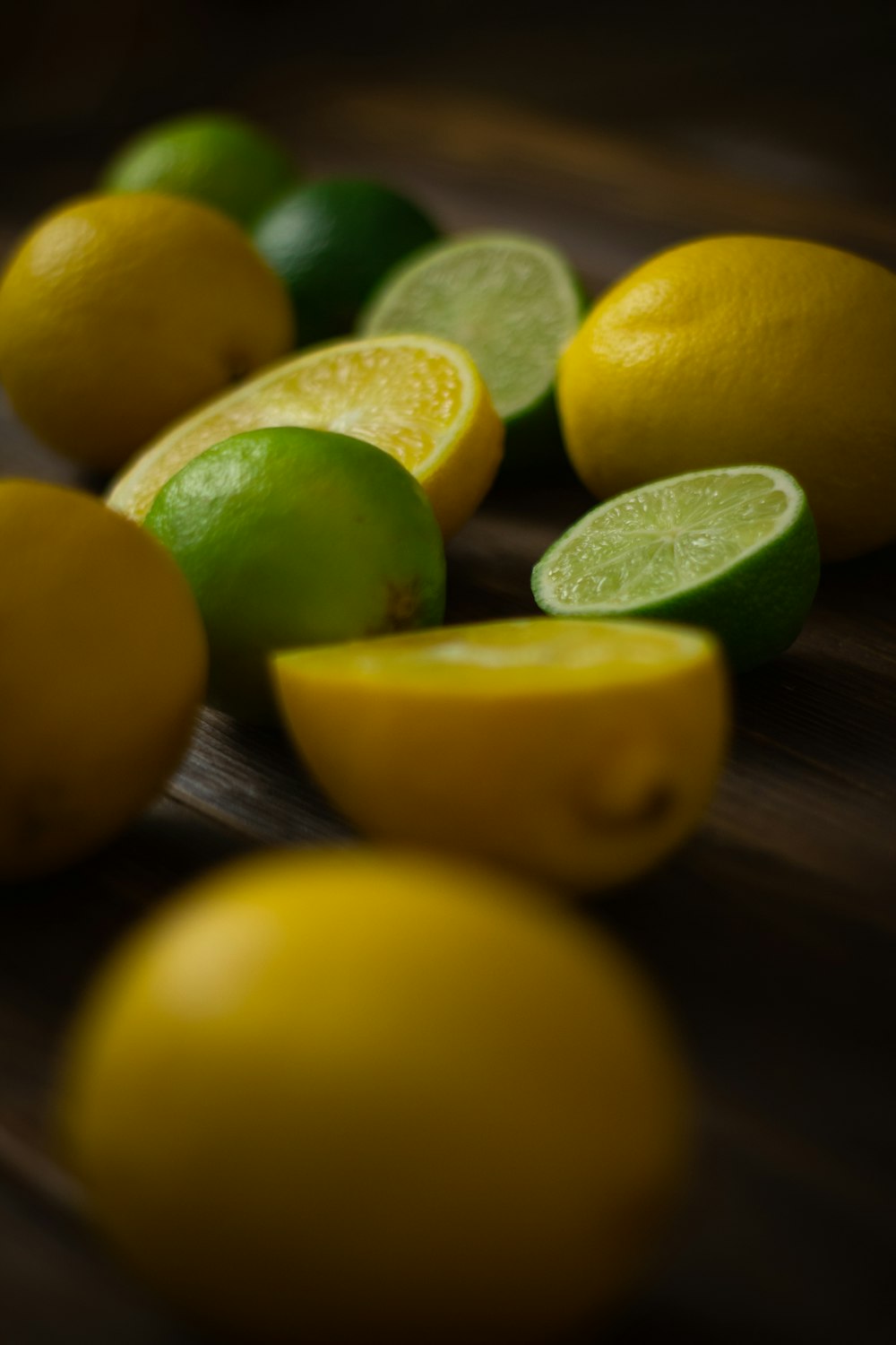 a group of lemons and limes on a table