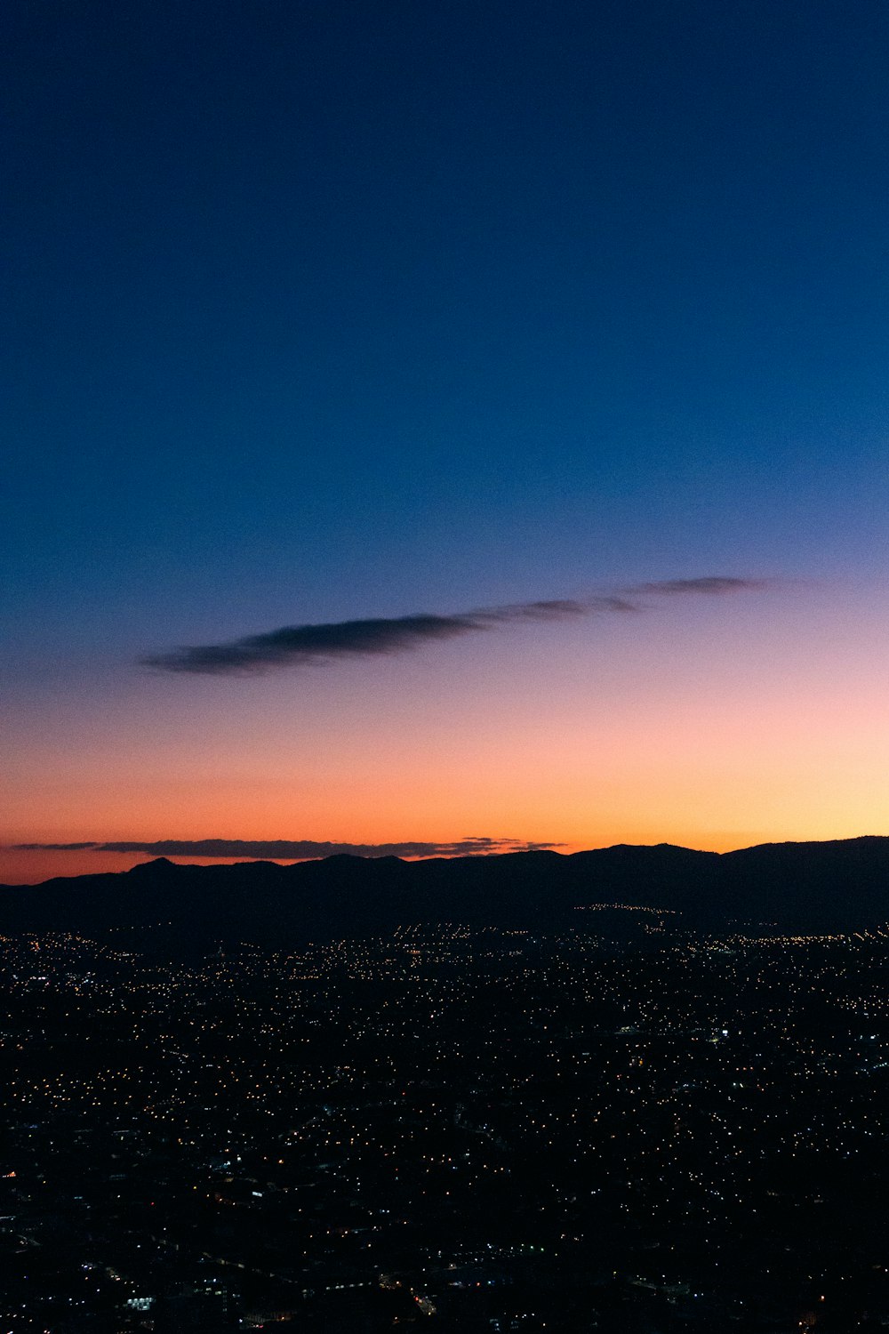 a view of a city at sunset from a plane