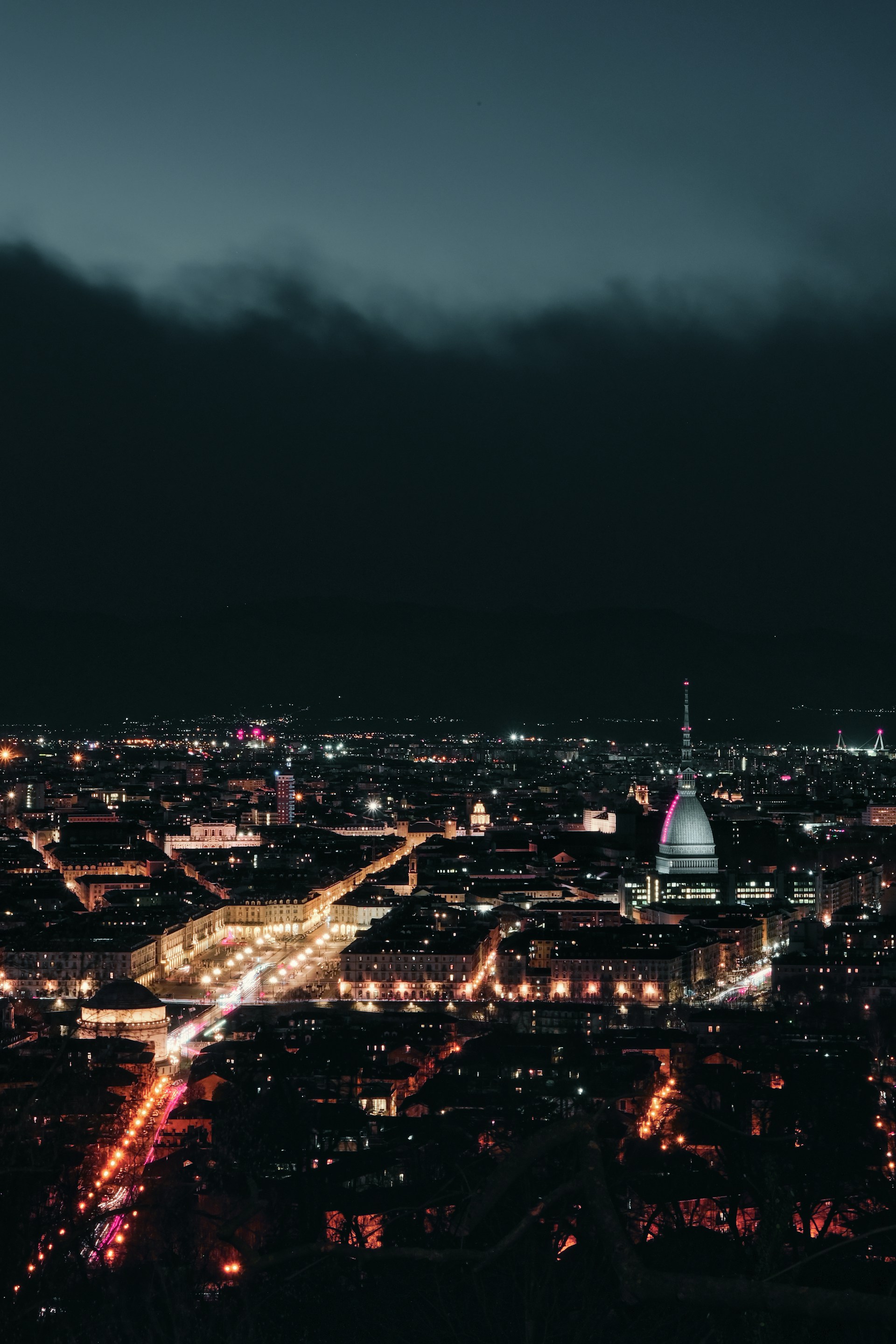 a view of a city at night from the top of a building