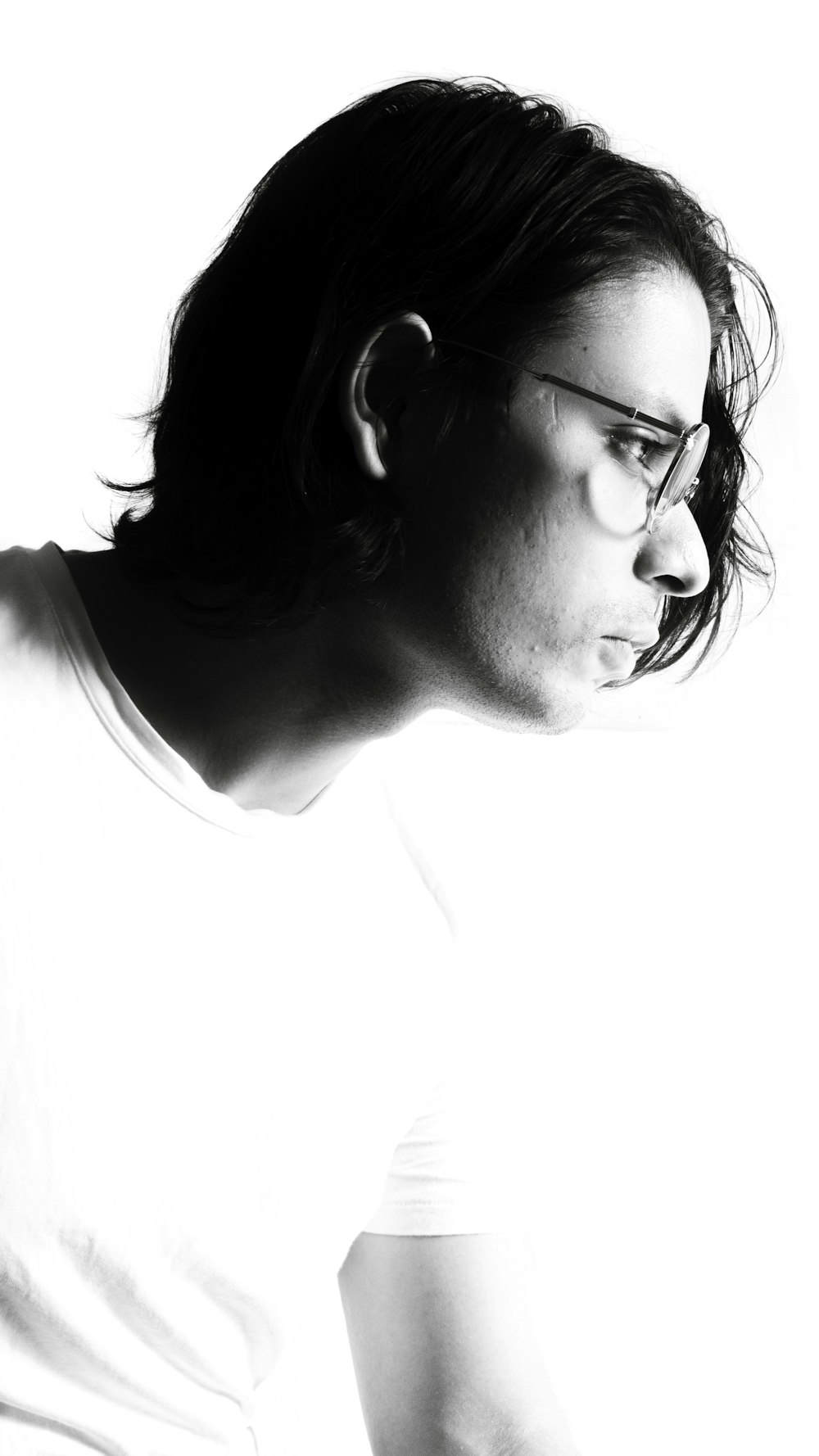 a black and white photo of a person with glasses