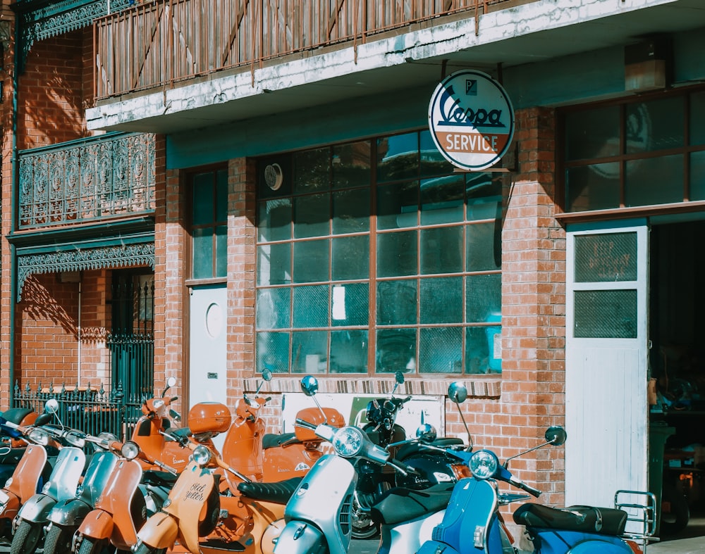 a row of motorcycles parked in front of a building