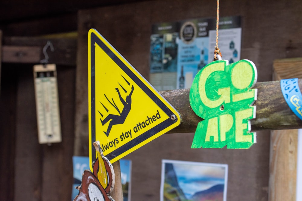 a close up of a street sign on a wooden pole