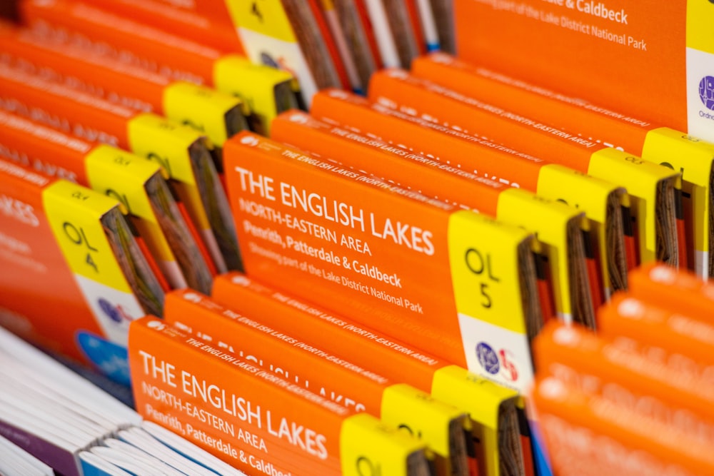 a bunch of orange and yellow books on a shelf