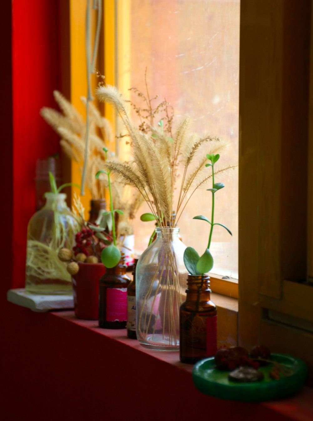 a window sill filled with vases filled with flowers