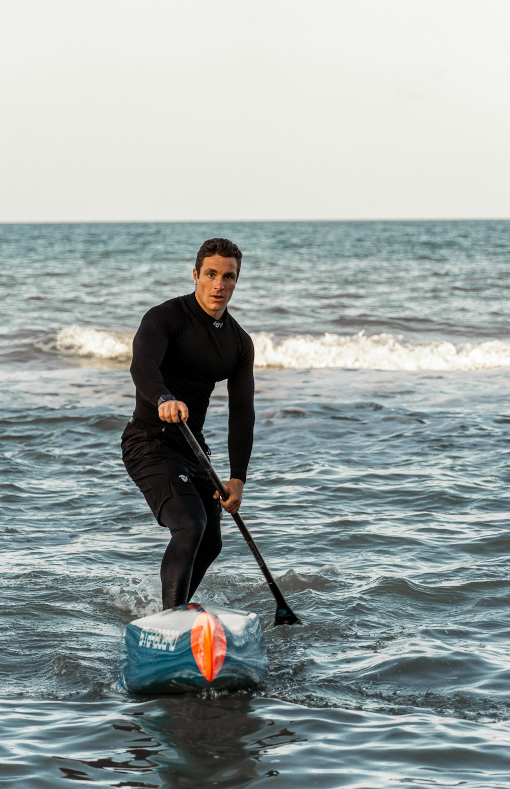 a man standing on a surfboard in the ocean