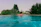 Couple relaxing by the swimming pool surrounded by lush greenery at aamby valley lonavala