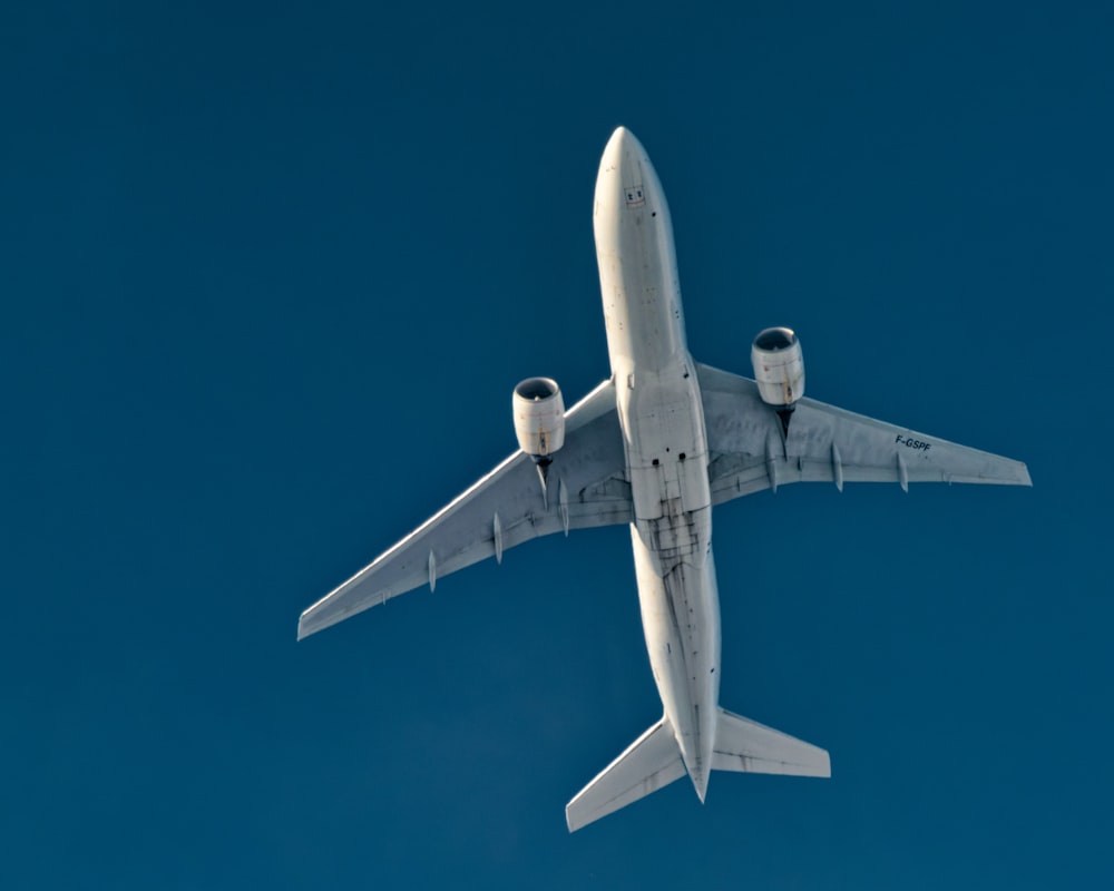 a large jetliner flying through a blue sky