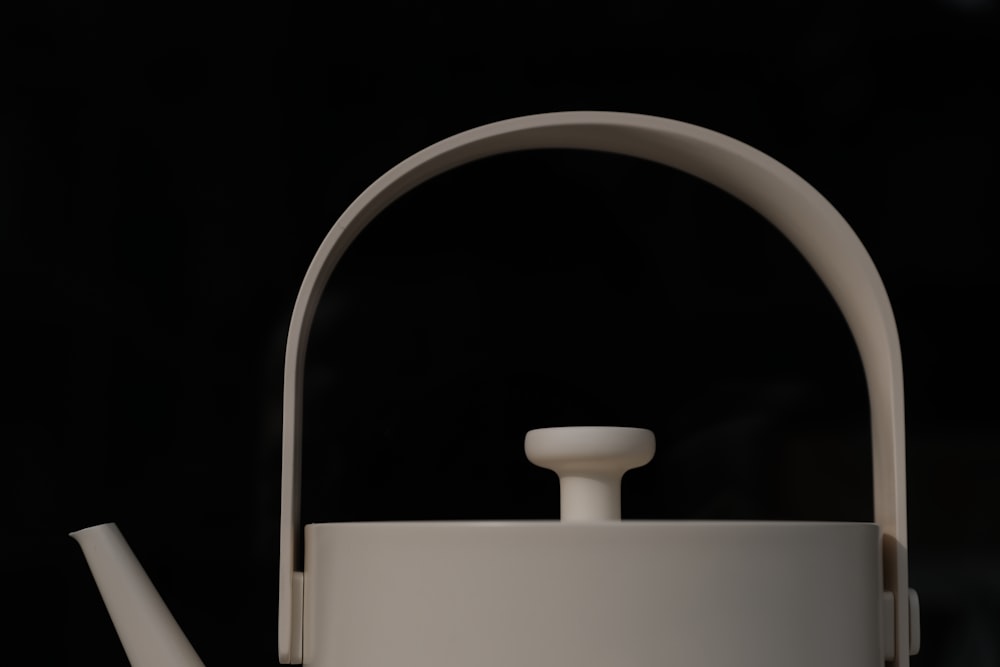 a white tea pot with a white handle