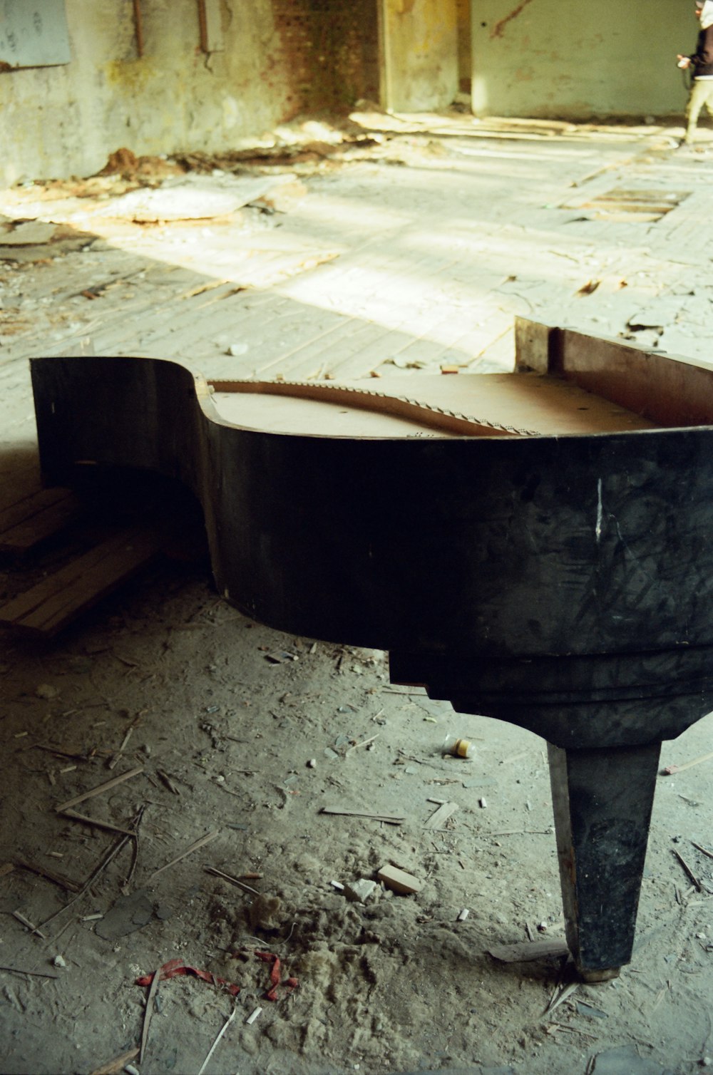 a black piano sitting on top of a wooden floor