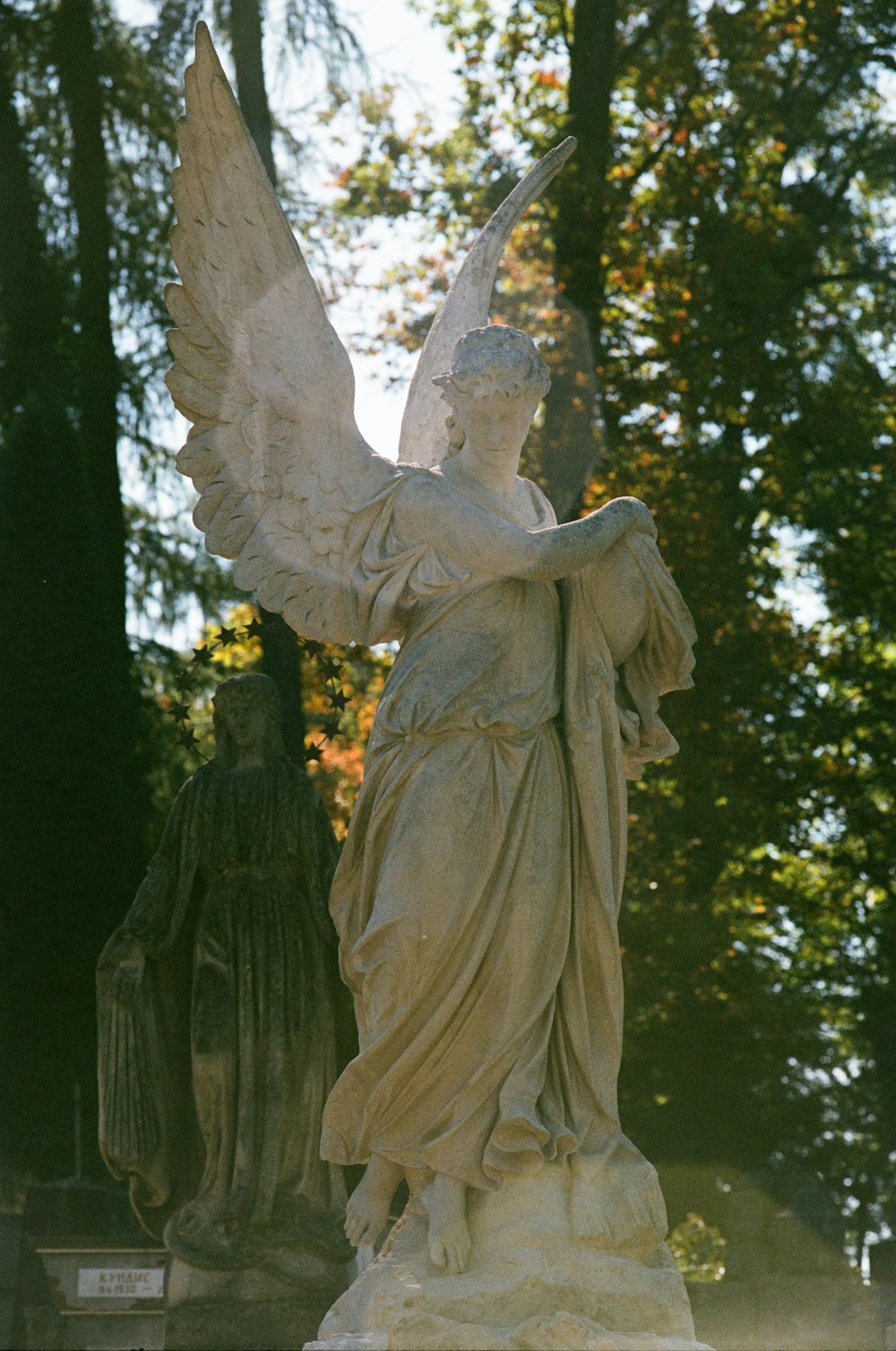 a statue of an angel holding a staff