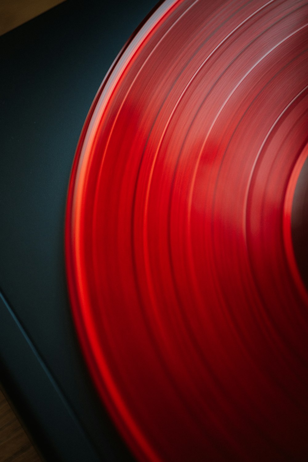 a close up of a red record on a black surface