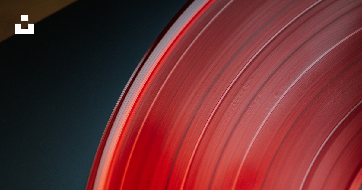 A close up of a red record on a black surface photo – Free Red Image on ...