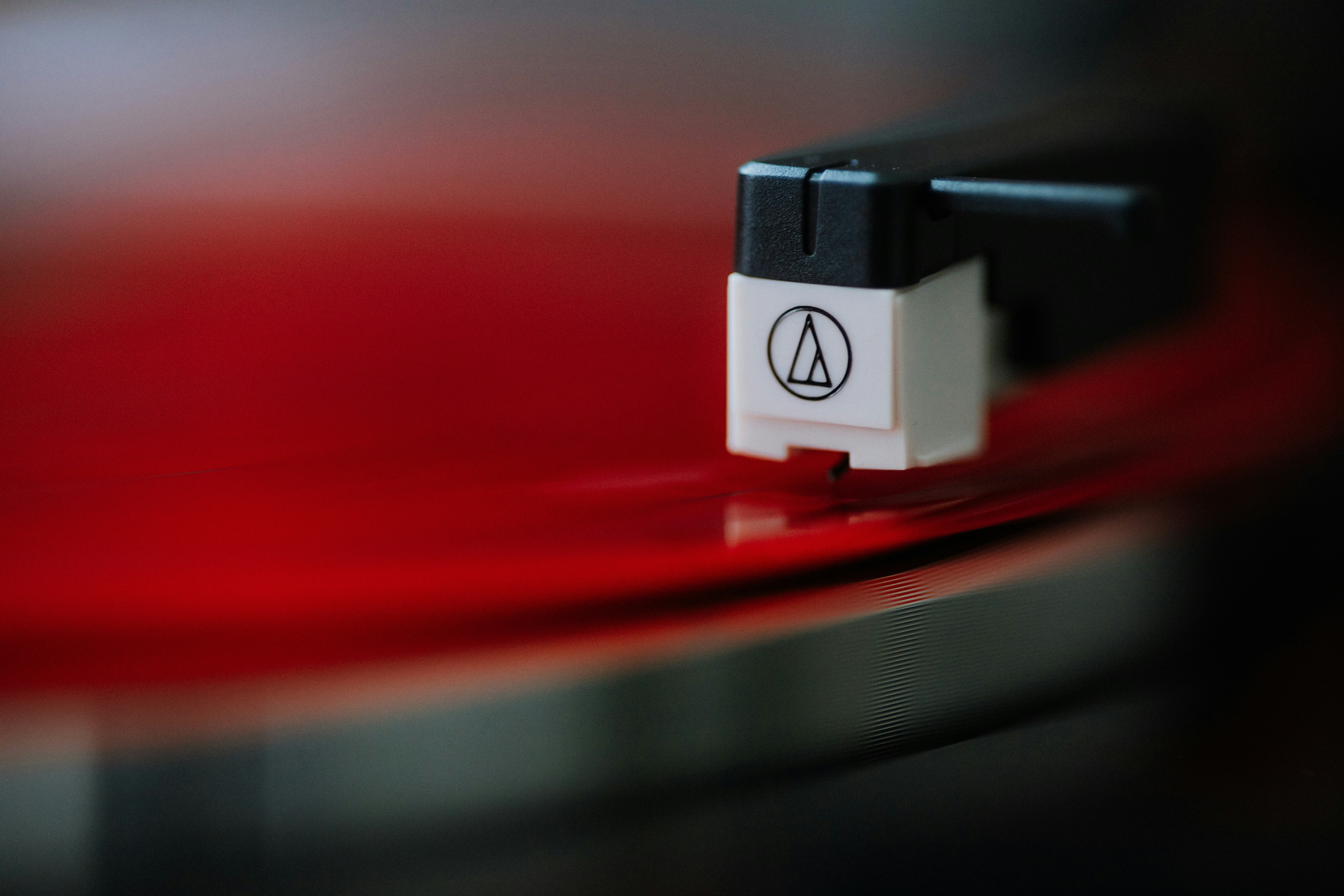 a close up of a red record with a black and white logo