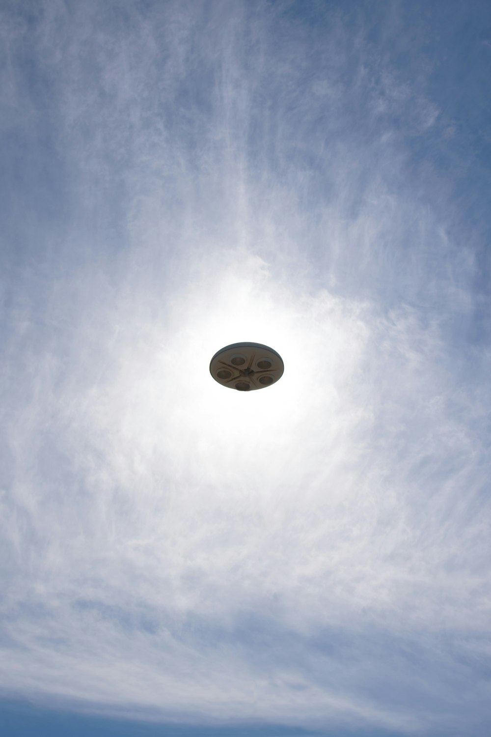 a frisbee flying through the air with a blue sky in the background