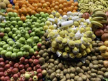 Brightly colored assortment of fresh fruits packaged for sale.