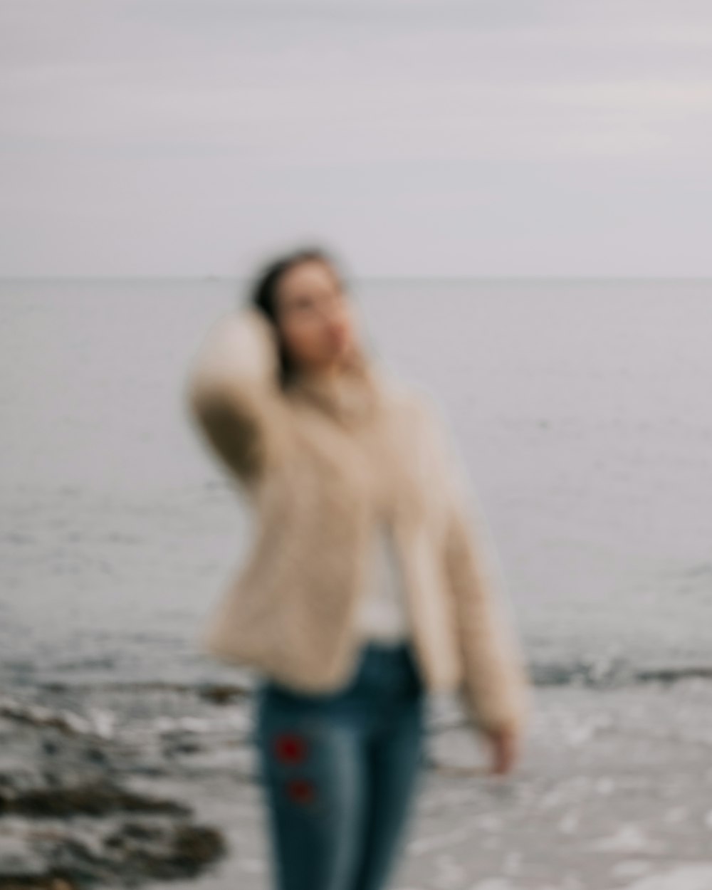 a blurry photo of a woman on the beach