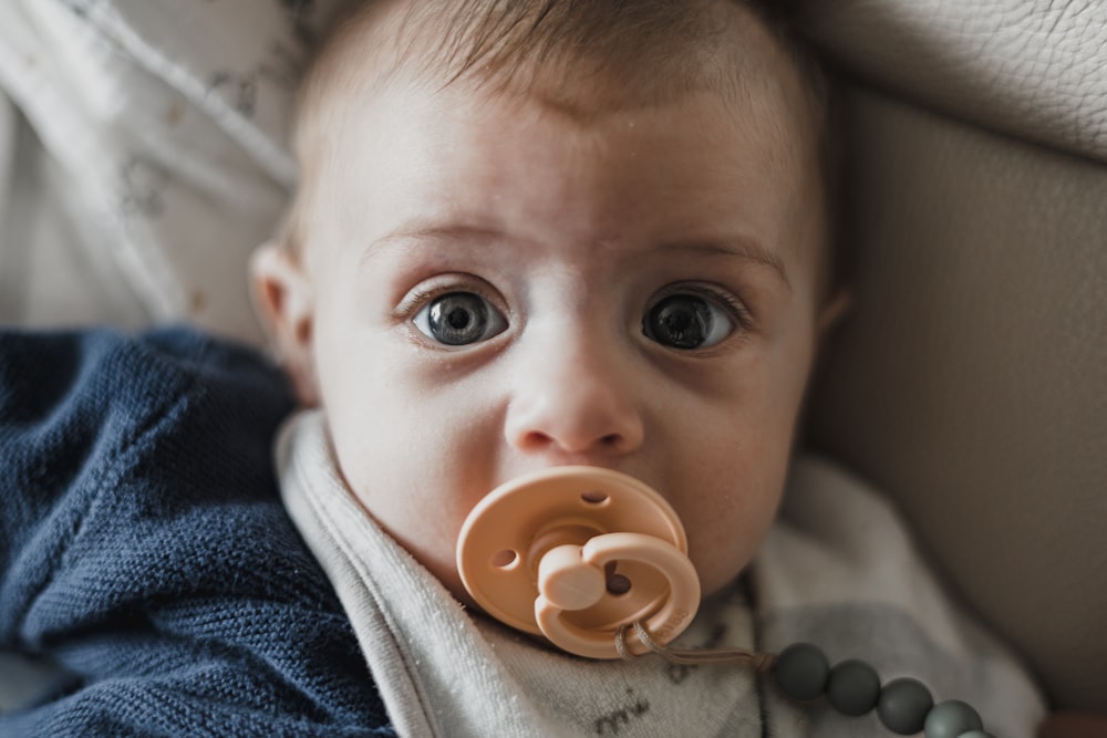 a baby with a pacifier in its mouth