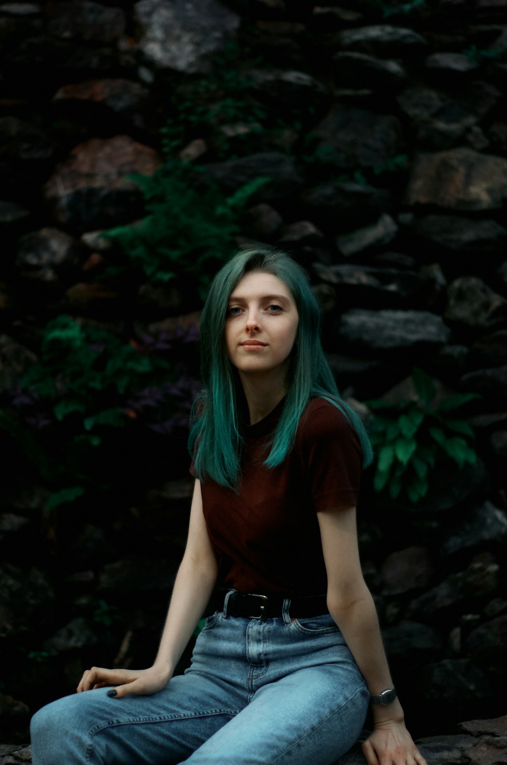 a woman sitting on a rock