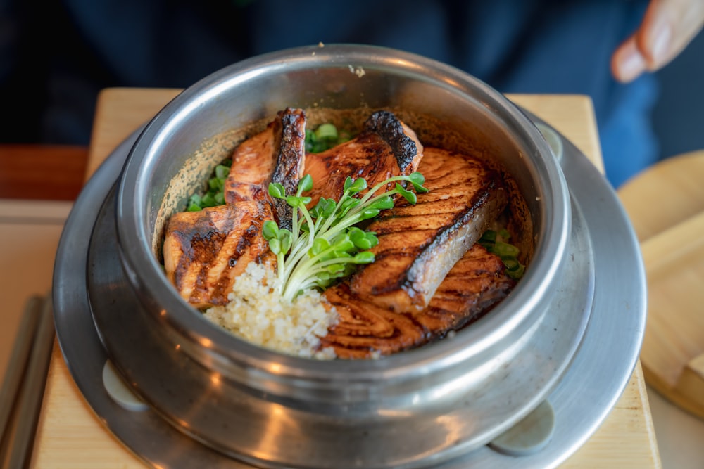 a bowl of food with meat and rice