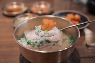 a spoon with some food in it on a table