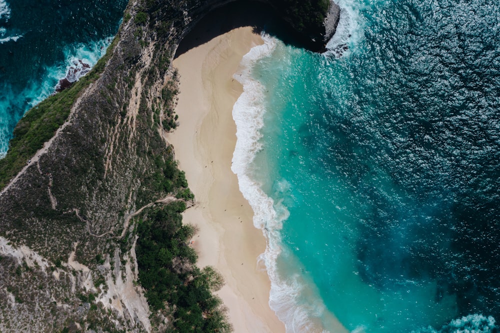 an aerial view of a sandy beach and ocean