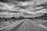 a black and white photo of an empty road