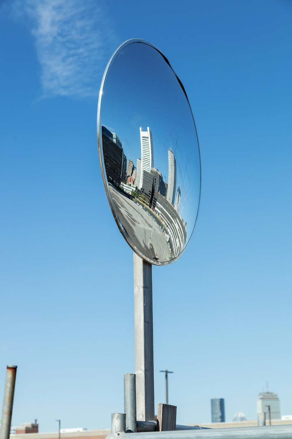 a reflection of a city in a round mirror