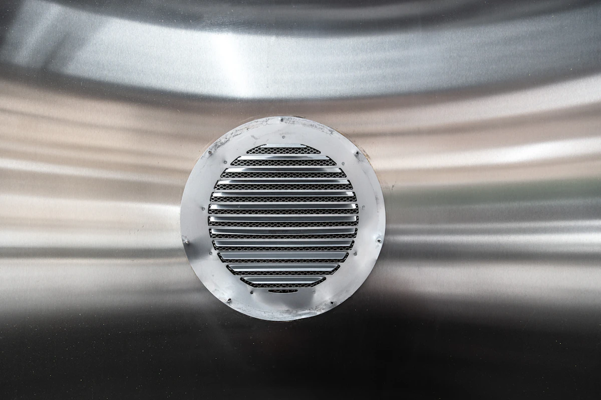 Modern air vent grille installed in a home ceiling, ready for summer cooling season
