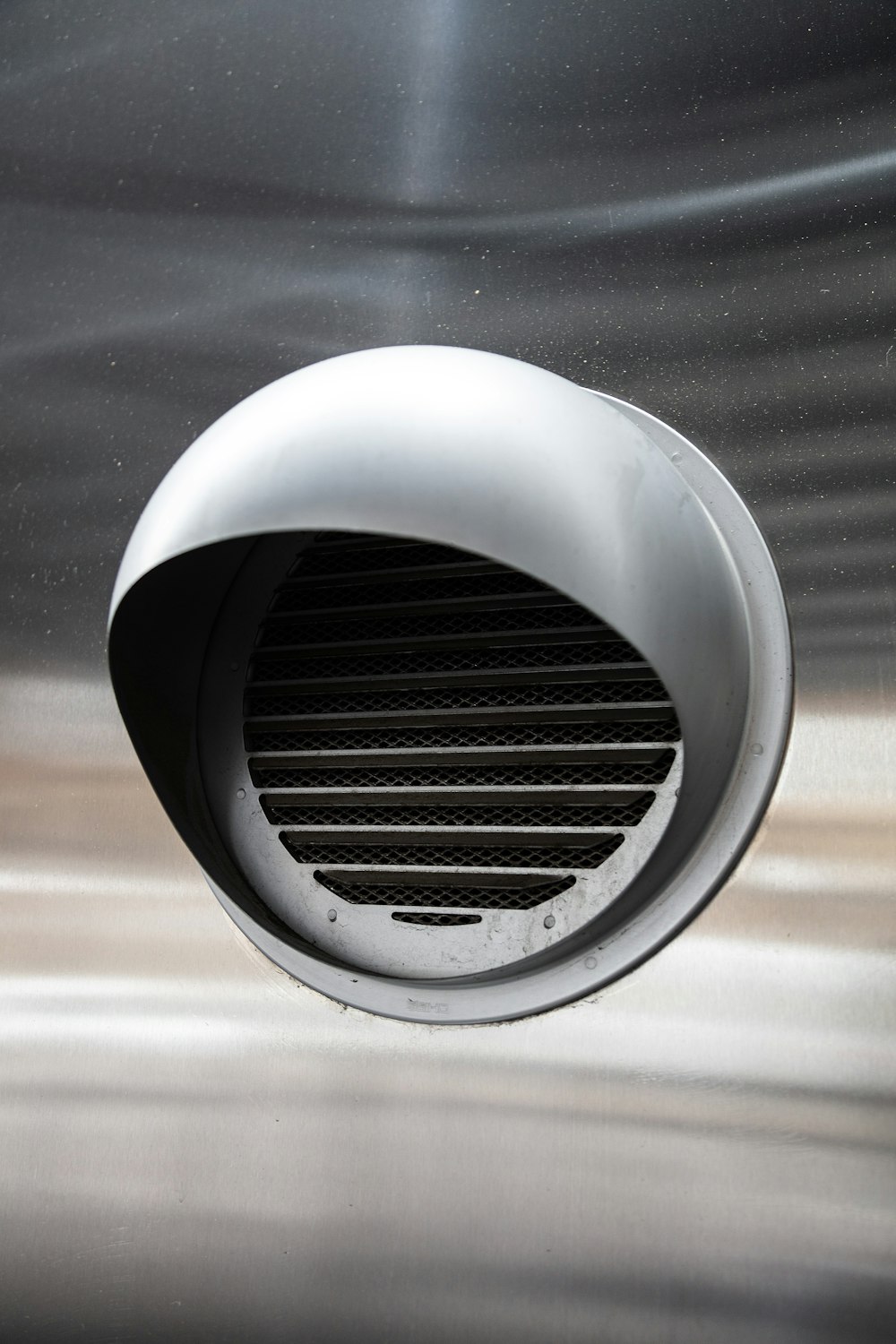 a close up of a vent on a metal surface