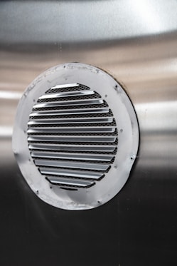 a close up of a metal object with a round hole