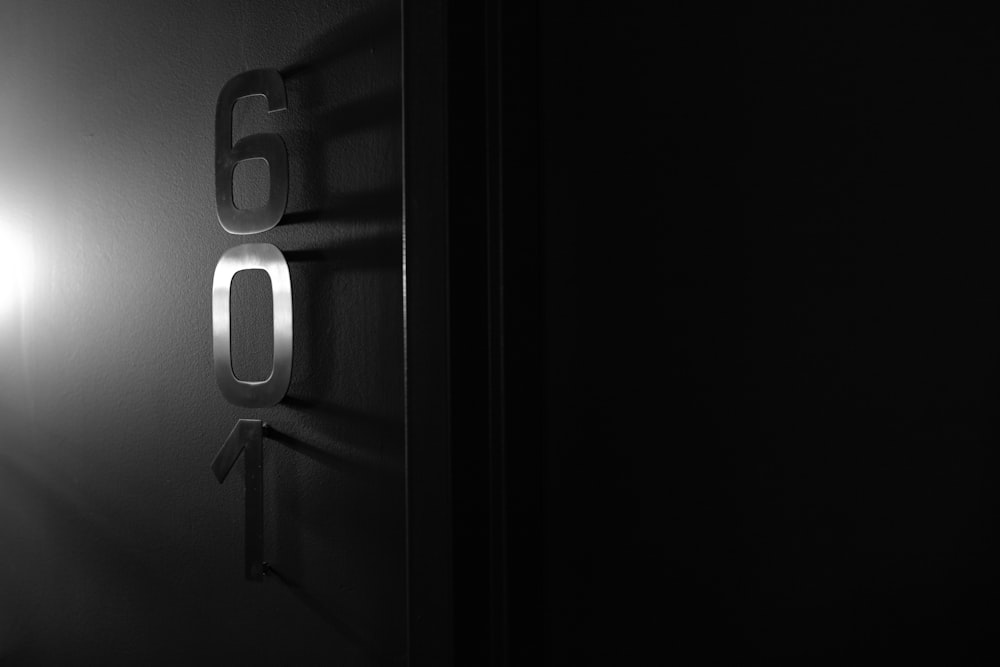 a black and white photo of a door with the number sixty on it