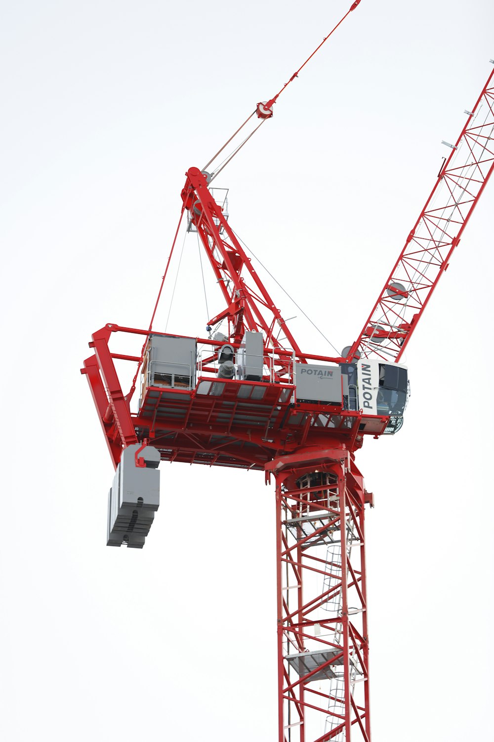 a large red crane is in the air