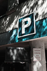 a parking sign on the side of a building