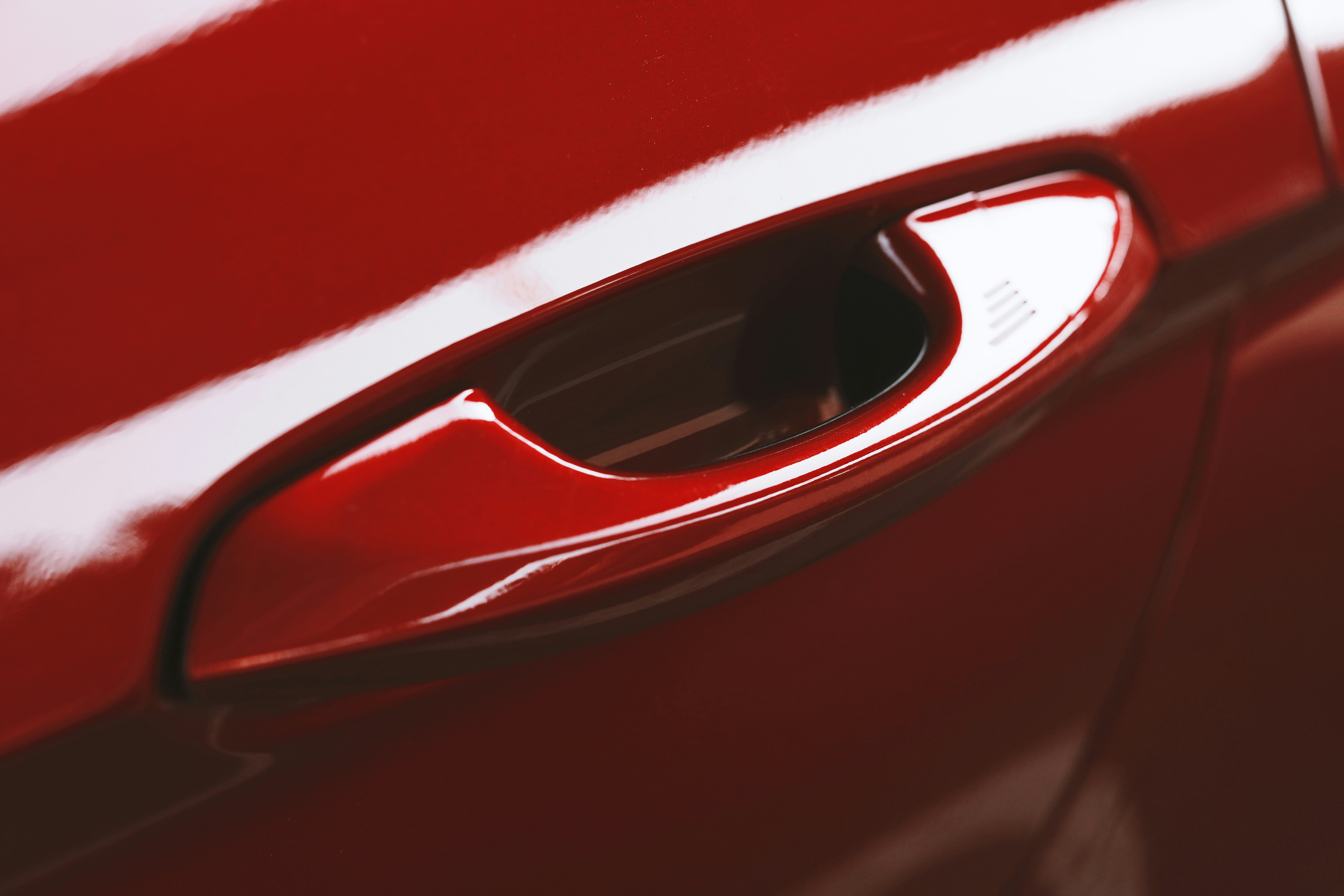 A close up of a red car door handle photo Free Colors Image on Unsplash