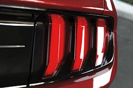 a close up of the tail lights of a red car