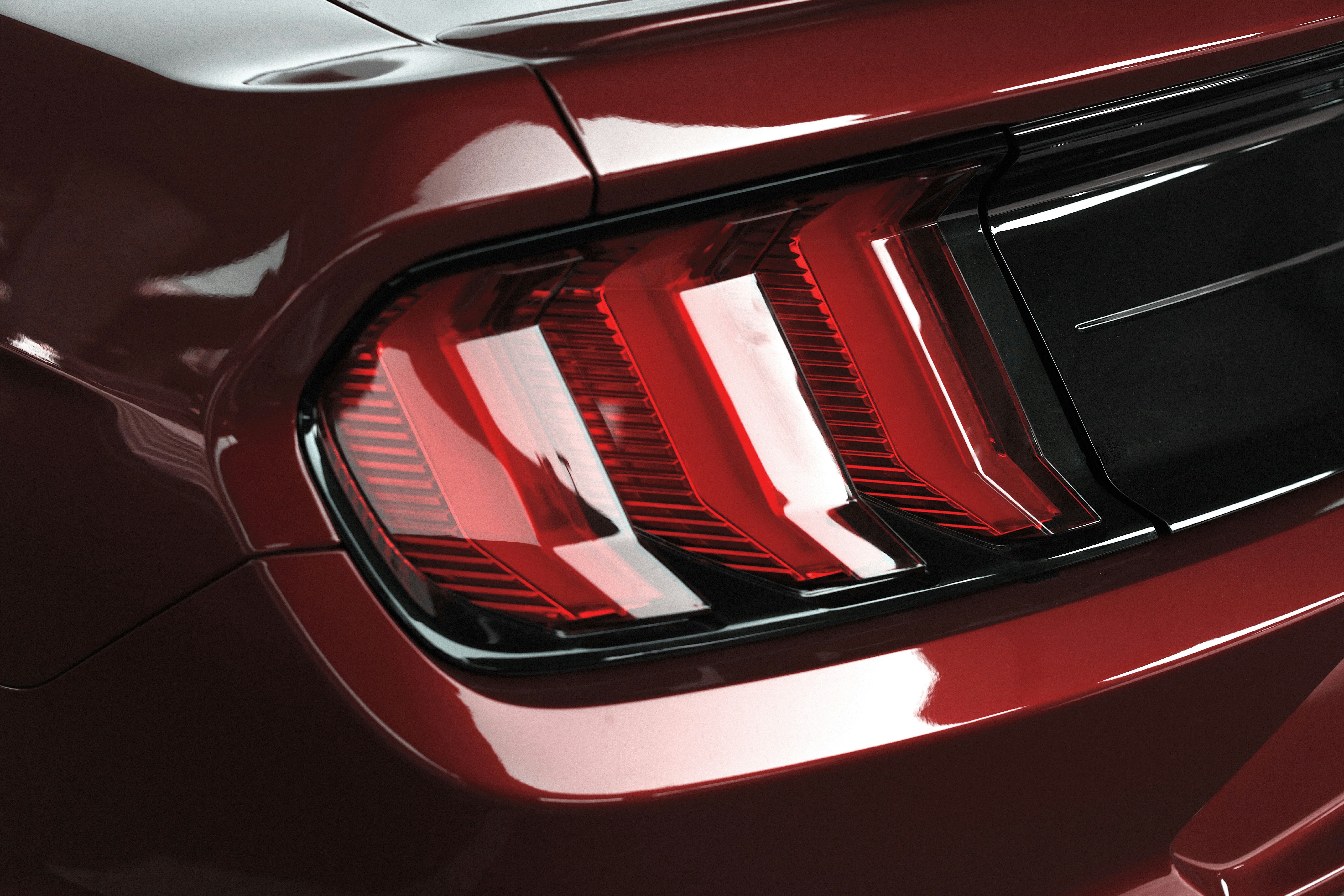 a close up of the tail lights of a red car