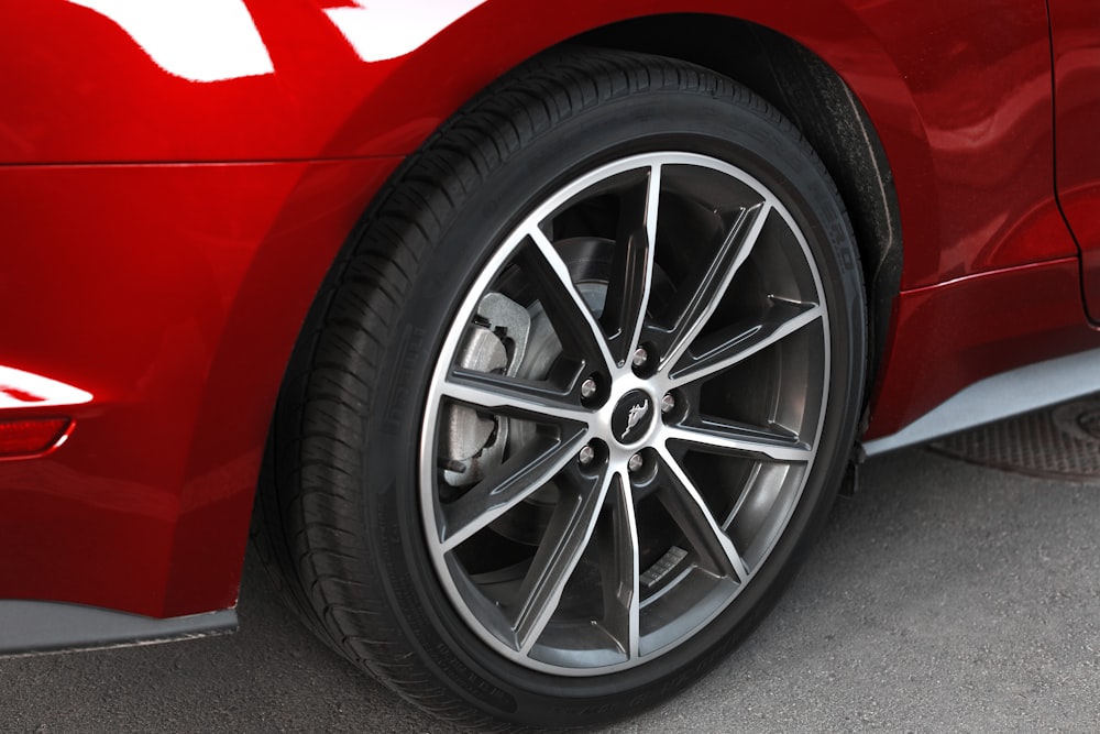 a close up of the spokes on a red car