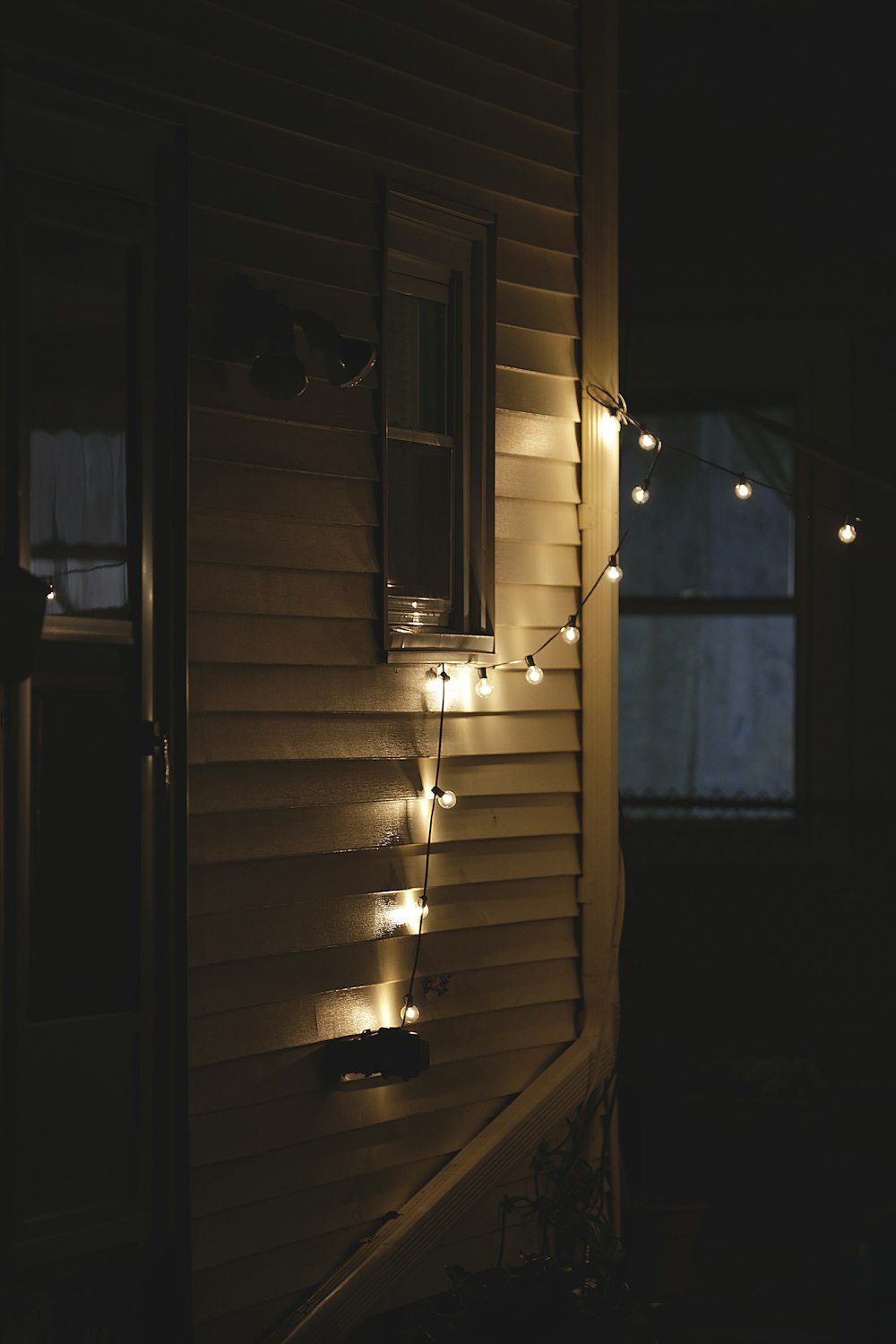 a house with some lights on the side of it