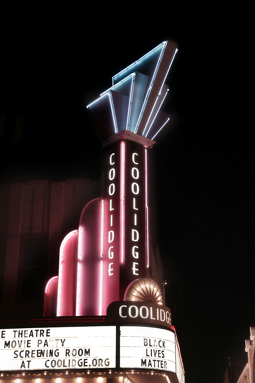 a building with a neon sign on top of it