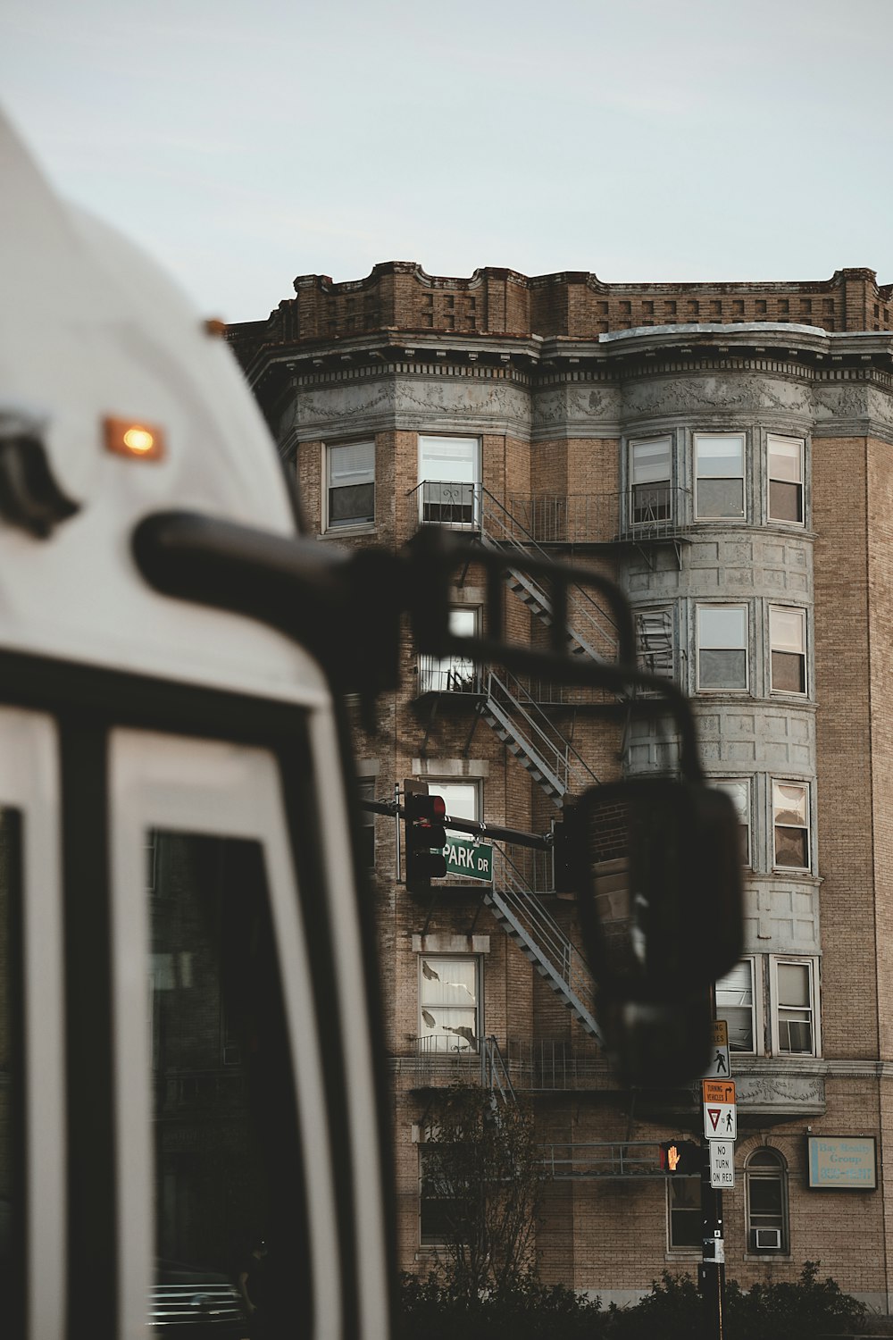 a white truck parked in front of a tall building