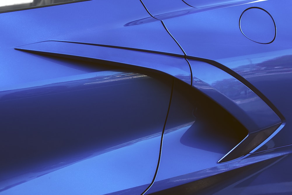 a close up of a shiny blue car