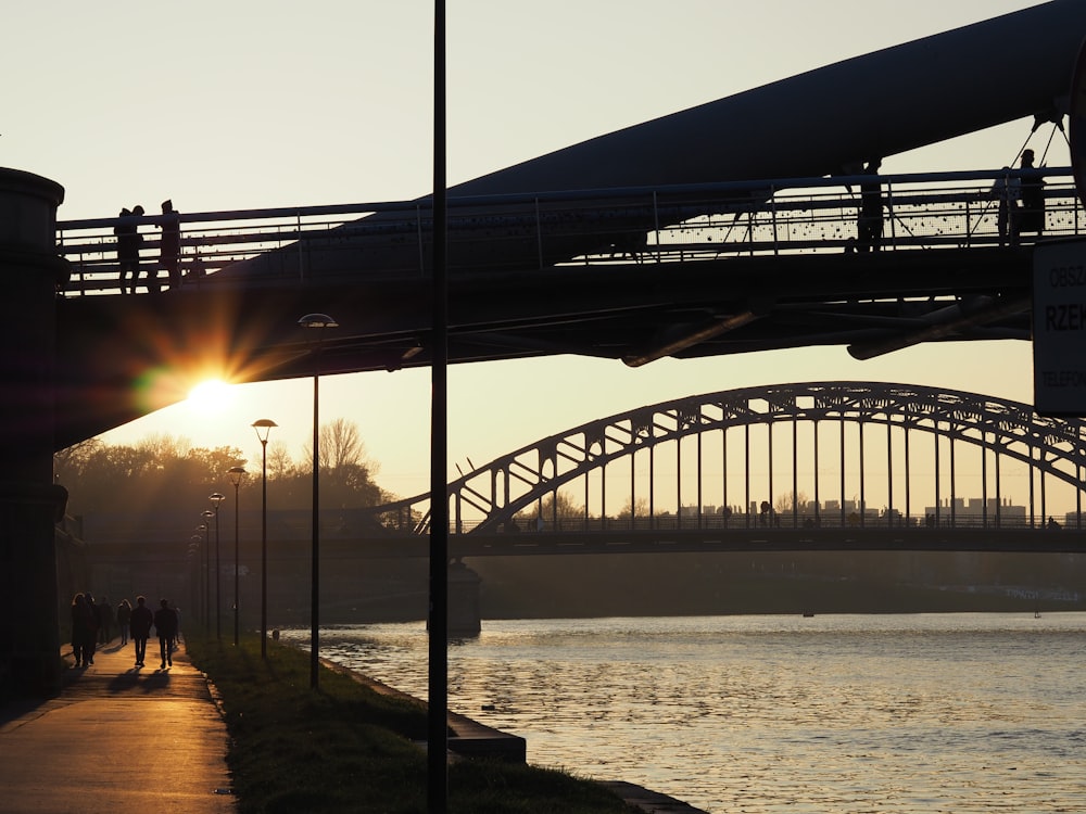 a bridge over a body of water at sunset