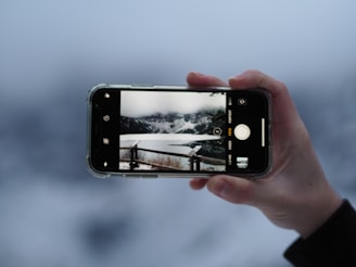 a person taking a picture with their cell phone