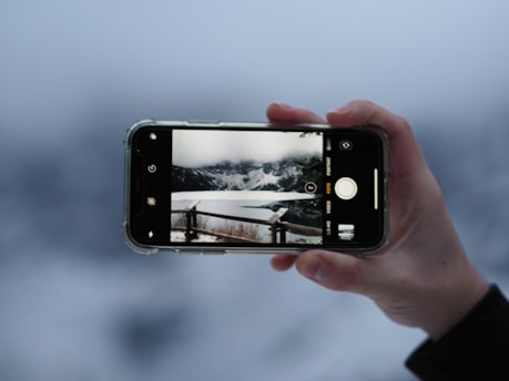 a person taking a picture with their cell phone