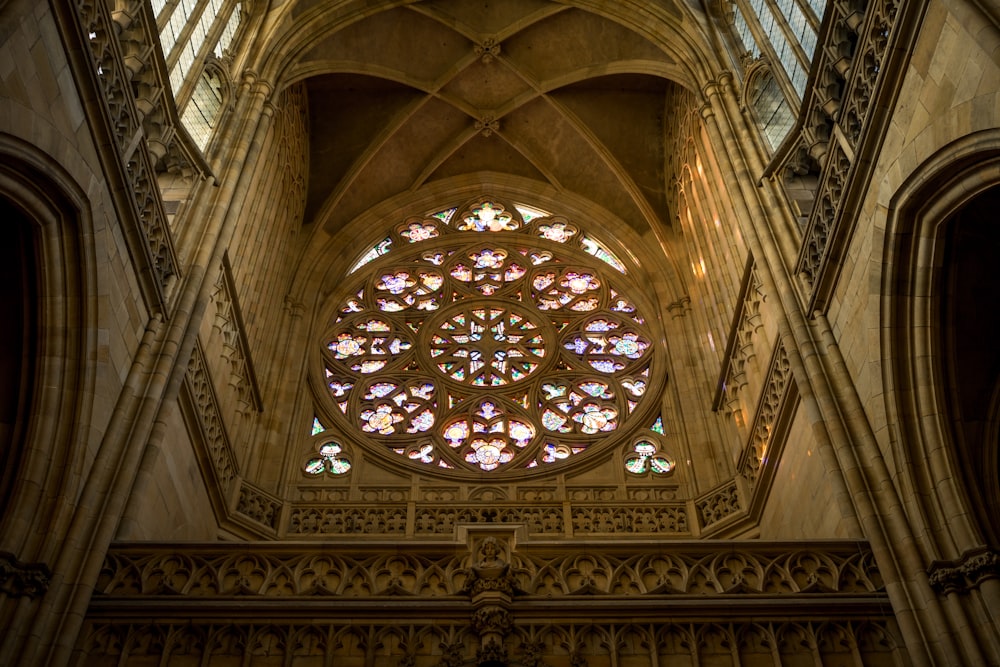 a large stained glass window inside of a cathedral