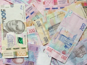 a pile of different bank notes laying on top of each other