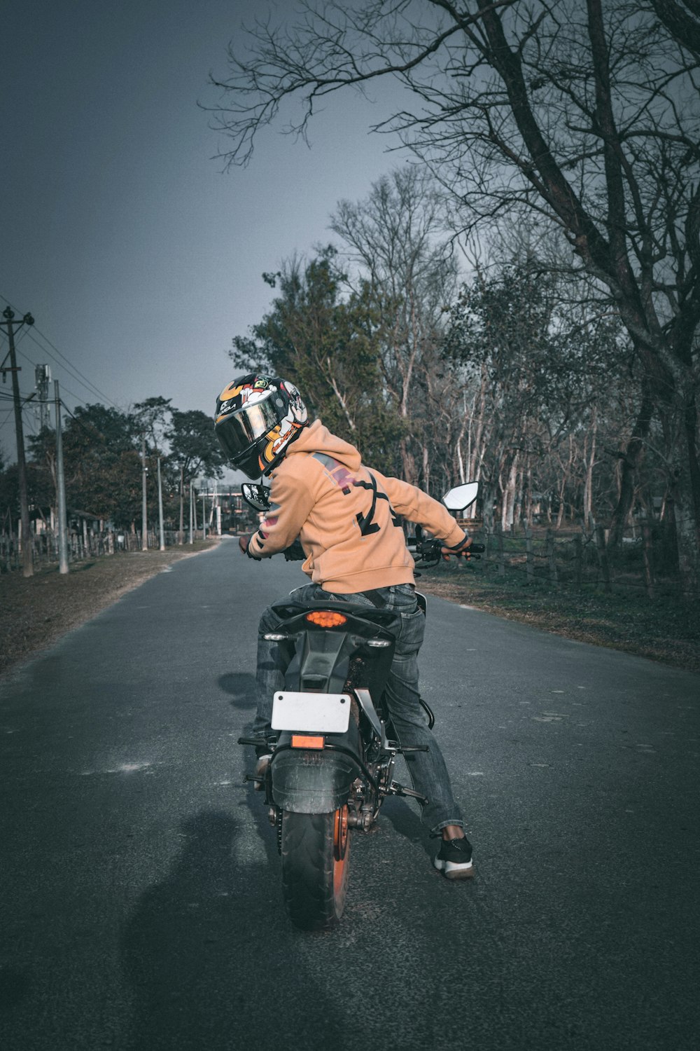 a man riding a motorcycle down a street