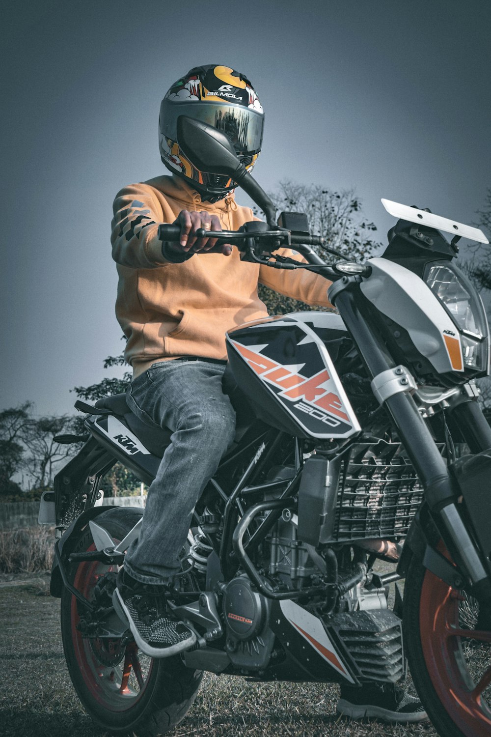 a man wearing a helmet sitting on a motorcycle