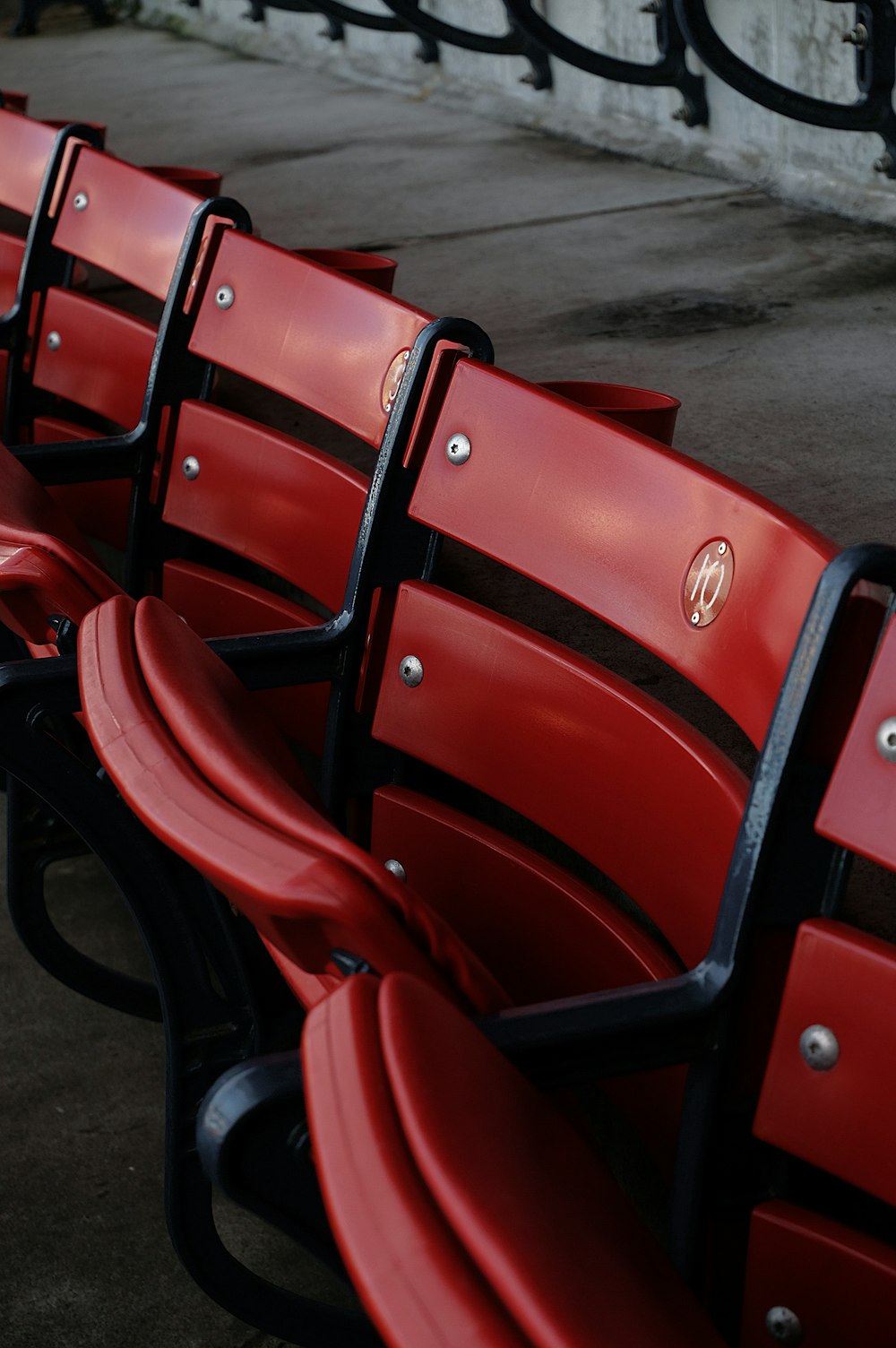 a row of red seats sitting next to each other